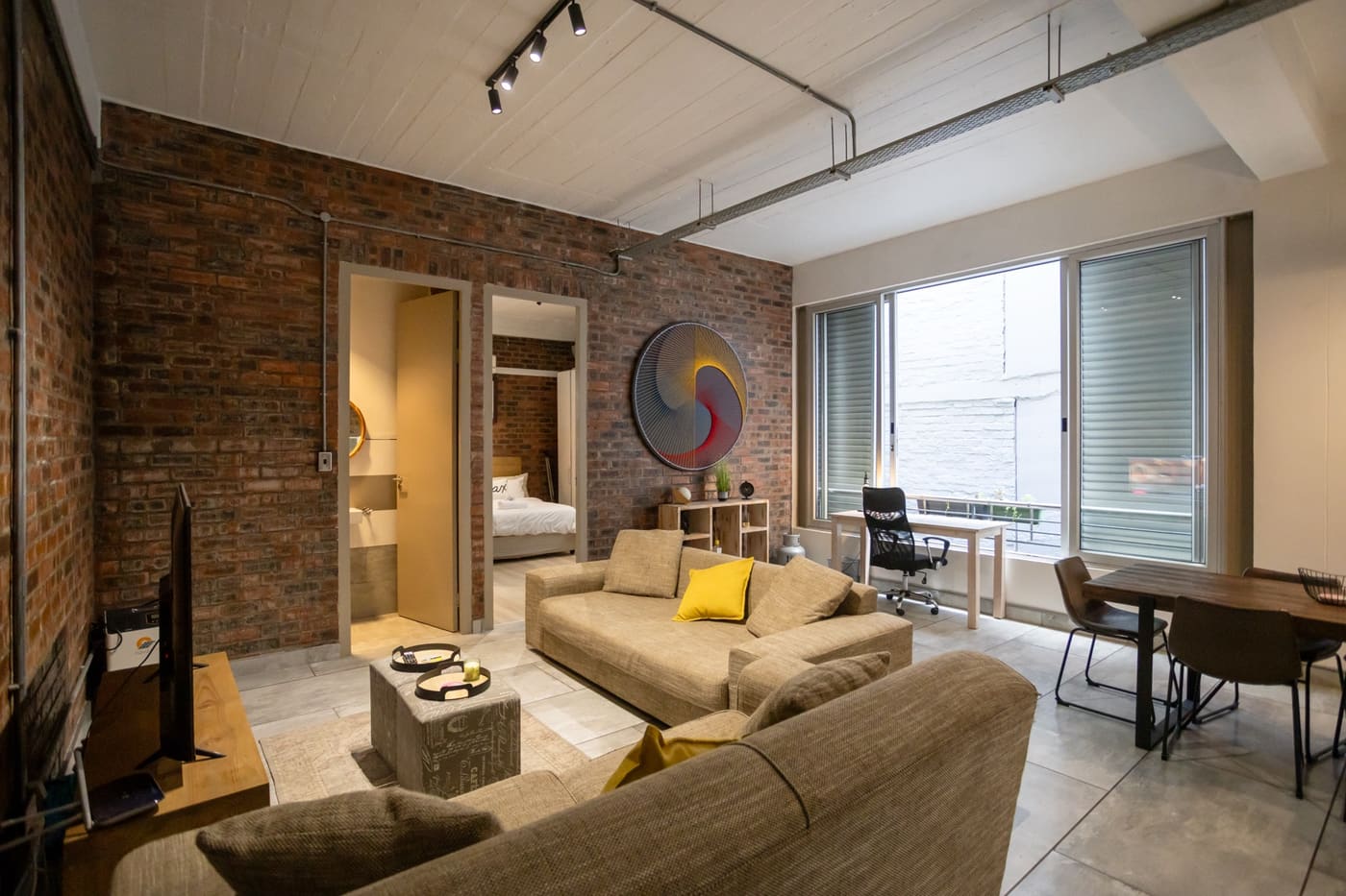Exposed-brick living room in the Gardens apartment